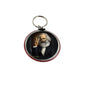 Round Marx keychain holder with portrait medallion, red edge, metal ring.