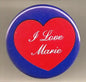 Round blue pinback button with red heart and white text 'I Love Marie'