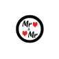 Round pinback button with black rim; white center with “Mr & Mr” and red hearts