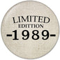 Round pinback button, beige fabric with black "LIMITED EDITION 1989-" text