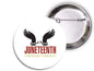 Round Juneteenth pinback button with black shackled-hands icon and “Juneteenth Celebrate Freedom” text