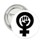 Round pinback button with black raised fist and female symbol