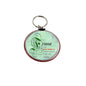 Round mint-green keychain with red border and “Friend” quote text
