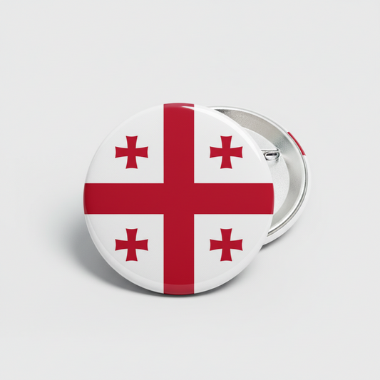 Button badge with a red cross design on a white background