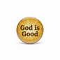A round, glossy gold button or pin with the words 'God is Good' printed in dark brown serif text, set against a plain white background.