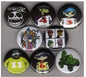 Twelve round pinback buttons with assorted black, green, and multicolor designs