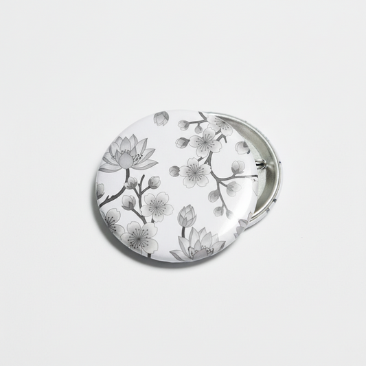 Grey oriental flower pinback button with round silver metal backing