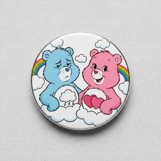 Round metal pinback badge with blue and pink bears holding red hearts and clouds