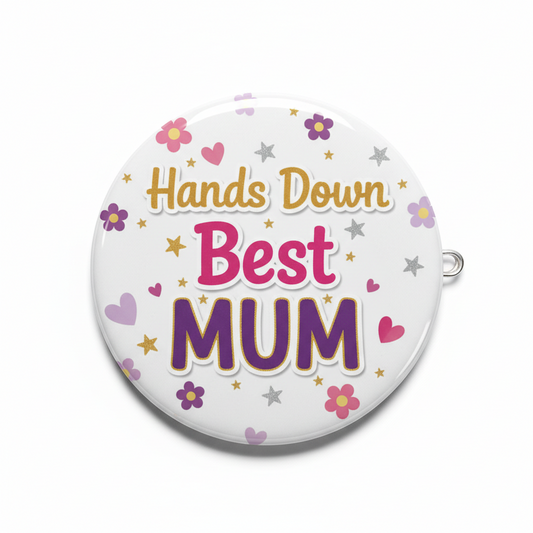 Round pinback badge: “Hands Down Best MUM” text with hearts, stars, and flower icons