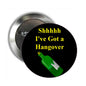 Hangover pinback button with yellow text and green bottle on black background