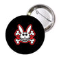 Black round pinback with bunny skull graphic and crossed bones, silver back clasp