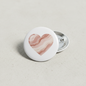 2.25-inch pinback button with heart-shaped stone pattern and silver back pin