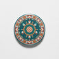 Circular pinback with teal border and colorful Native-inspired geometric pattern