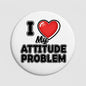Round white pinback button with red heart and bold black “Attitude Problem” text