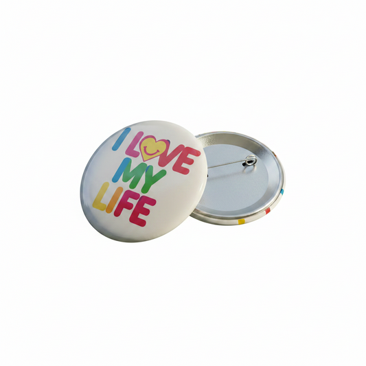 Pinback button with clasp open, showing I LOVE MY LIFE design and heart