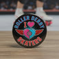 2.25-inch black roller derby skaters pinback button with heart and wings design