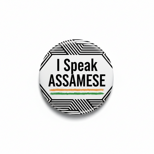 Round pinback button with “I Speak ASSAMESE” text and black-and-white geometric border