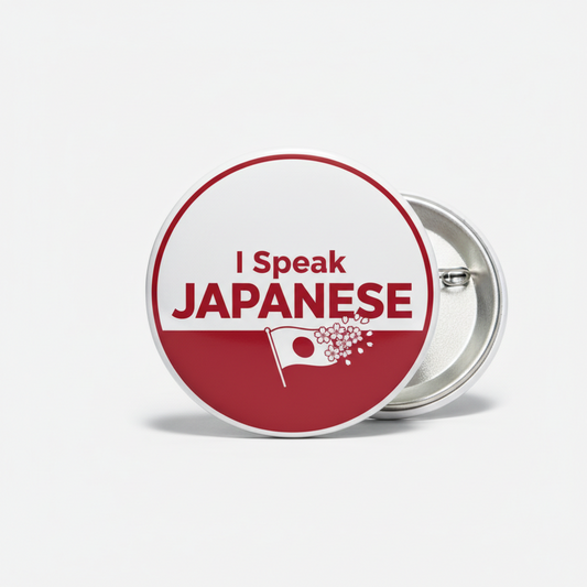 Round pinback button: 'I Speak JAPANESE' on red-and-white with small flag icon
