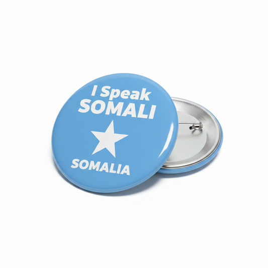 Blue circular pinback button: 'I Speak SOMALI' with star and 'SOMALIA' text.