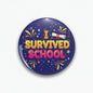 2.25-inch button pin with “I Survived School” text and fireworks graphics