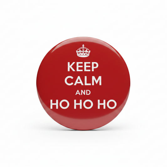 A round red button badge with a silver metal rim, featuring a white crown and the text 'KEEP CALM AND HO HO HO' in white, centered on a plain white background.