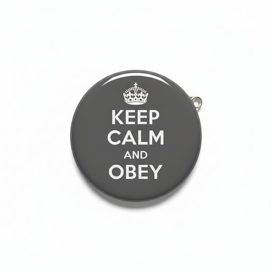 Grey button pinback badge with crown and text “KEEP CALM AND OBEY”