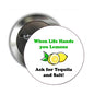 Round pinback button with lemon graphic and text “When Life Hands you Lemons”