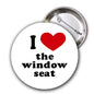 Round travel pinback button with red heart and text 'I love the window seat'.