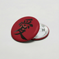 Red circular pinback button with black Chinese character and silver metal clasp