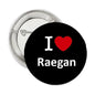 Round black I heart Raegan pinback brooch with red heart and white lettering, silver clasp.