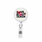 Retractable badge reel with round white face reading "LOVE TEACH" and heart icons