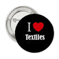 Round black pinback button with I ♥ Textiles text, red heart, silver back