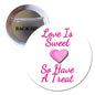 Round pinback button with 'Love Is Sweet So Have A Treat' and pink heart