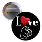 Pinback button: black face with heart and fist, silver back labeled 'BACK SIDE'