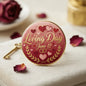 Round Loving Day pinback button with gold rim, hearts, wreath, and 'June 12' text