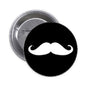 Round black pinback button with white mustache graphic and silver edge, 1.25-inch
