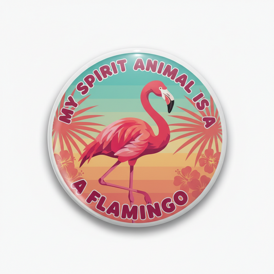 A round pinback button badge featuring a pink flamingo on a tropical sunset background with the text 'MY SPIRIT ANIMAL IS A FLAMINGO'.
