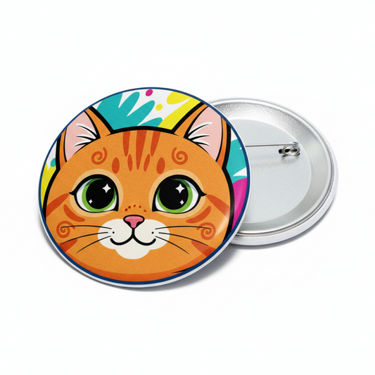 Round pinback button with orange cat face illustration and metal safety pin back