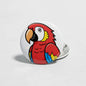 Red bird button pinback with colorful parrot illustration and metal back clasp
