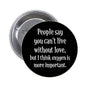 1.25-inch pinback button with black face and white quote text: "People say you can't live..."