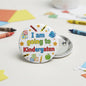 Round pinback button: 'I am going to Kindergaten' with colorful school icons