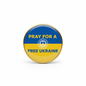 Round enamel-style pin with gold rim, blue and yellow design reading “PRAY FOR A FREE UKRAINE”