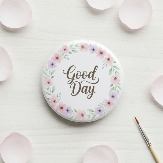 Floral wreath pinback button with “Good Day” text, pink and purple flowers, white background