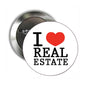 2.25-inch real estate pinback button with “I ♥ REAL ESTATE” and red heart