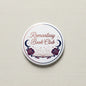 Romantasy Book Club pinback button with white background and blue title text, roses