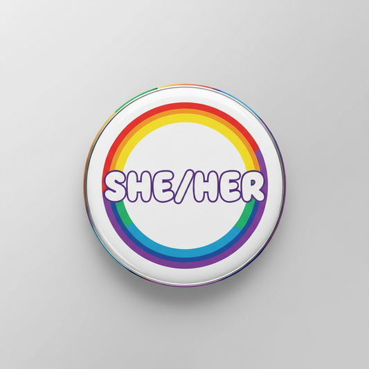 Rainbow circle pronouns pinback with SHE/HER lettering, silver rim, 2.25-inch