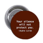 Round brown 1.25-inch pinback button with white quote text and Audre Lorde signature