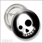 Round skull button pinback with black rim and white skull face, metal pin back.