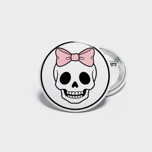 Skull pinback button with pink bow, round enamel style