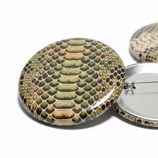 Snake-skin oval pinback button in green and gold with metal pin clasp